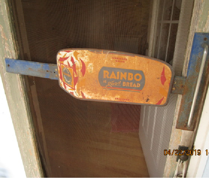 Rainbow Bread door handle sing push on an old fashion screen door. 