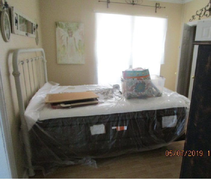 mattress and box spring covered with plastic