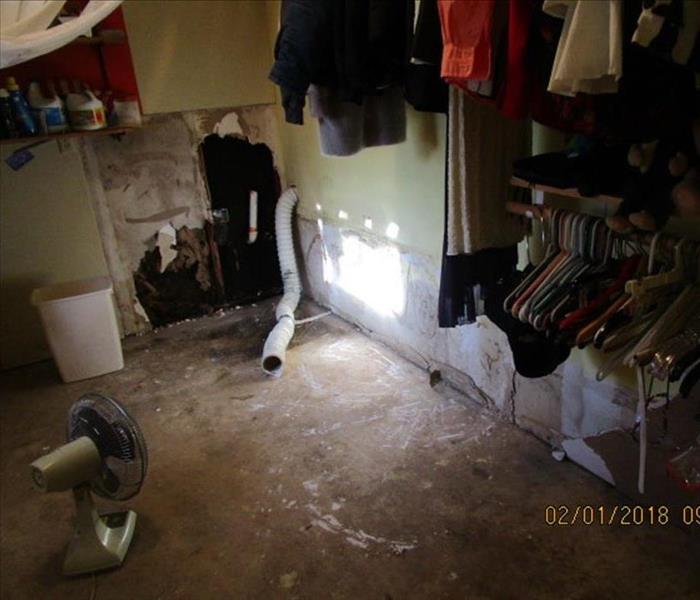 Utility room beside garage.  Wet walls had decorative layer over them.