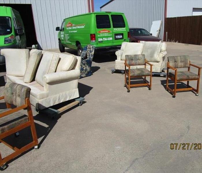 Furniture from a fire damage drying in the sunshine after cleaning