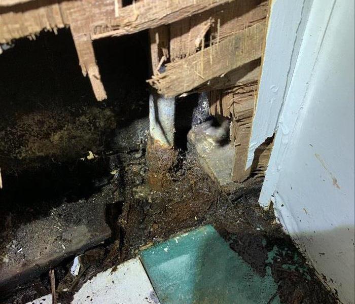 Picture shows an old galvanized pipe seriously rusted at the floor level