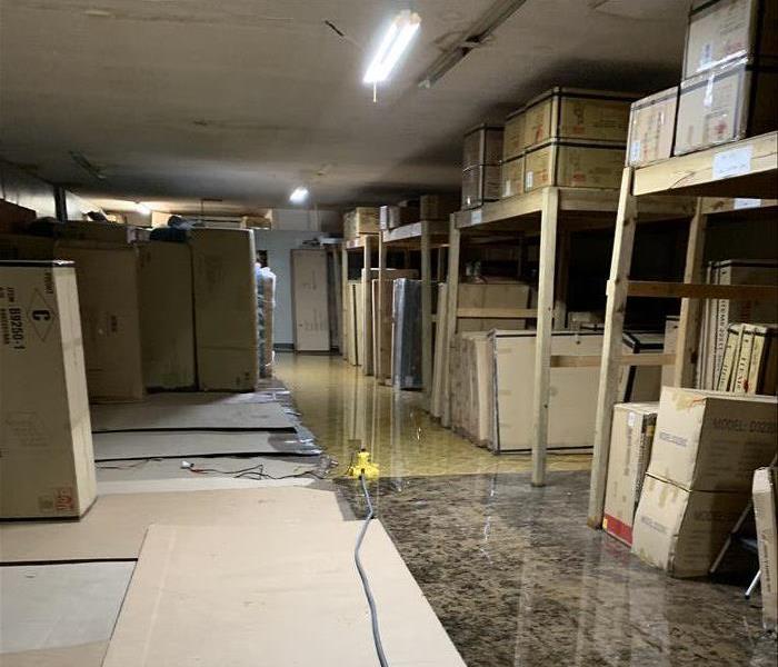 Flooded warehouse floor with inventory involved