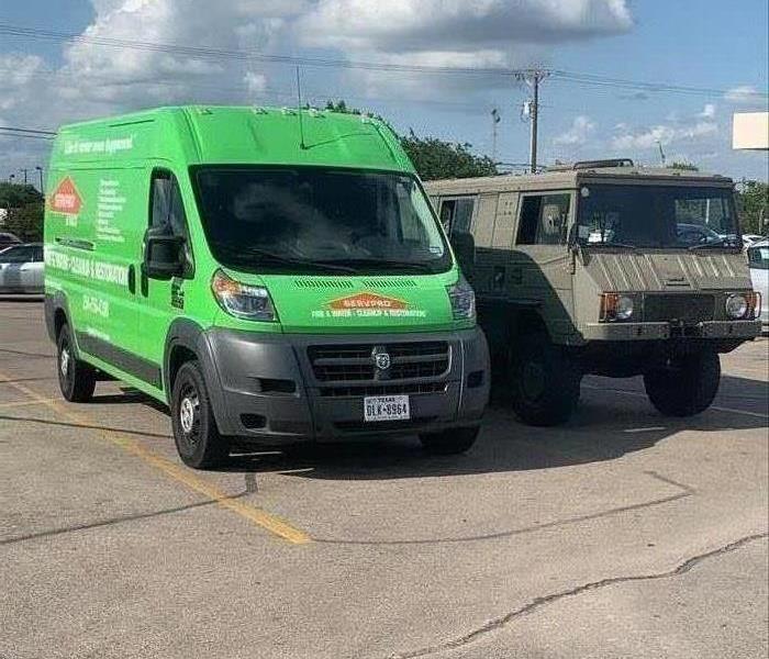 Military style off road vehicle parked next to the SERVPRO of Waco Promaster van. 