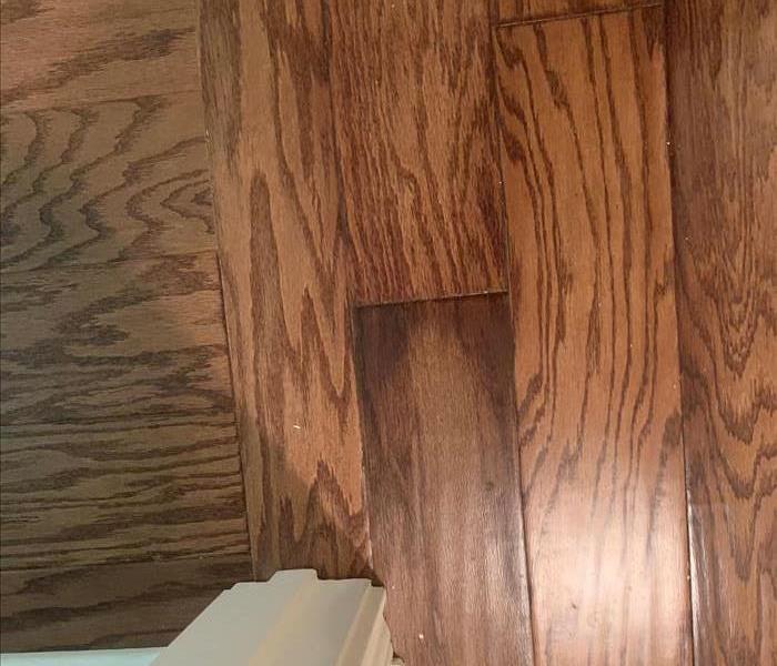 Hardwood floor with water stains showing through from the back side